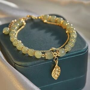 Radiant Double-Layer Green Beaded Bracelet with Sparkling Golden Leaf Charm